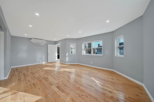 empty room with light hardwood / wood-style flooring