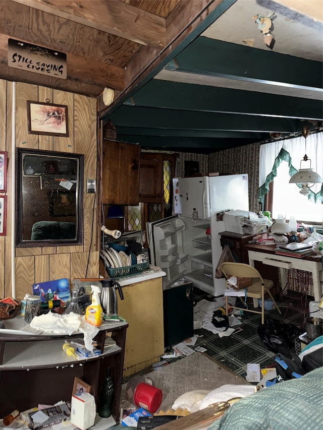 misc room with beam ceiling and wooden walls