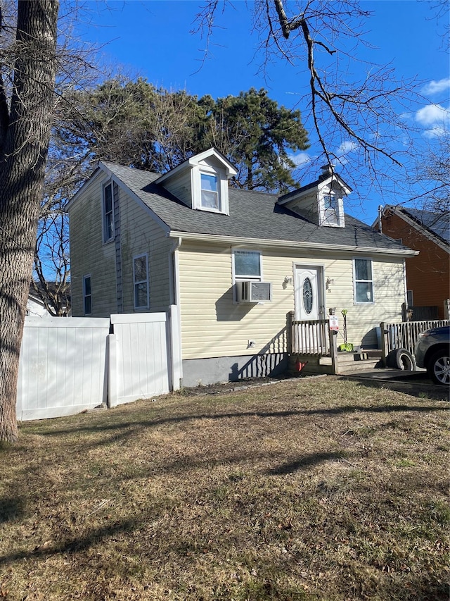 view of front of house featuring cooling unit and a front lawn