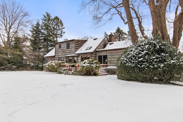 view of snow covered rear of property