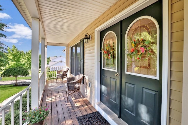 view of exterior entry with covered porch