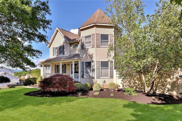 victorian house featuring a porch and a front lawn