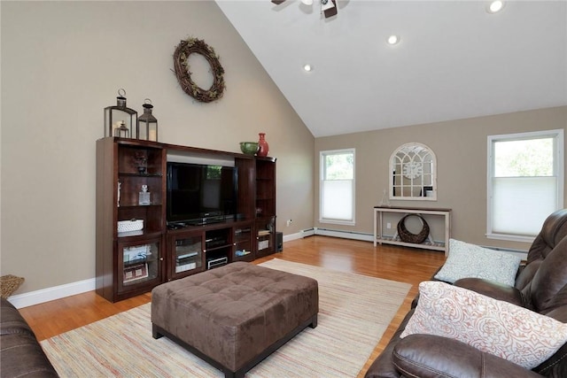 living area featuring high vaulted ceiling, recessed lighting, wood finished floors, and baseboards