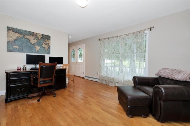 home office featuring a baseboard heating unit and light wood finished floors