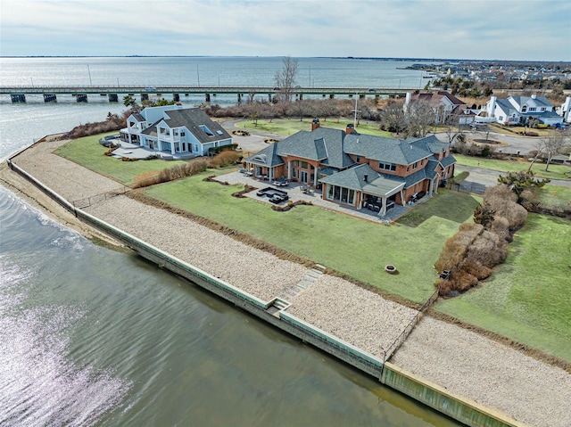 birds eye view of property featuring a water view and a residential view