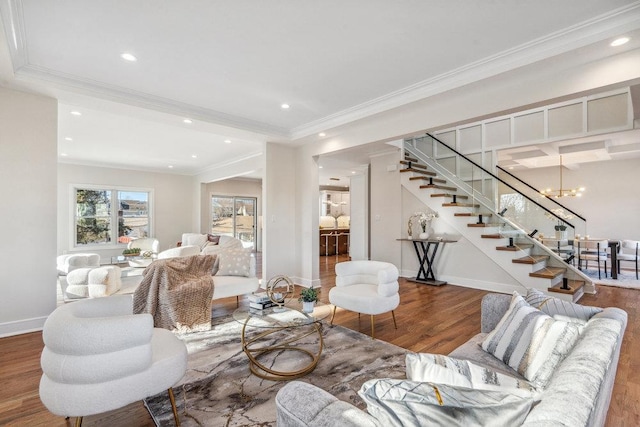 living room with crown molding, an inviting chandelier, and hardwood / wood-style floors