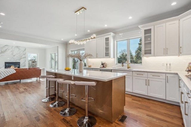 kitchen with pendant lighting, sink, and white cabinets