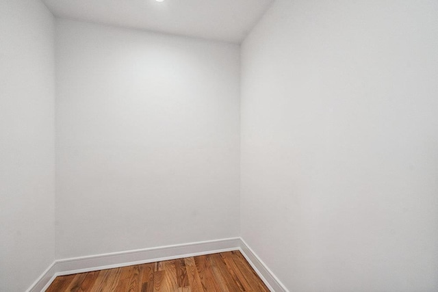 unfurnished room with hardwood / wood-style flooring