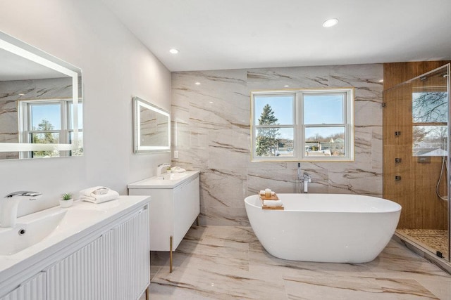 bathroom featuring vanity and shower with separate bathtub