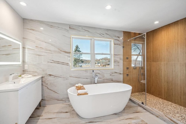 bathroom with independent shower and bath and vanity