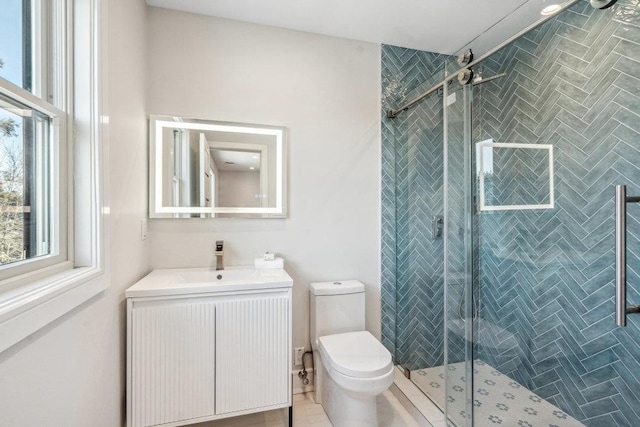 bathroom with vanity, toilet, and a shower with shower door