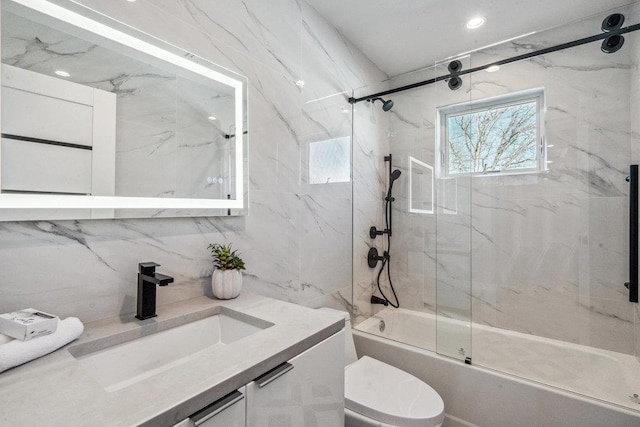 full bathroom with bath / shower combo with glass door, vanity, and toilet