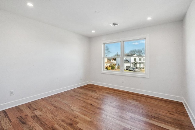 spare room with hardwood / wood-style flooring