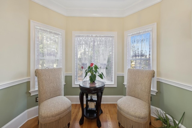 sitting room featuring crown molding, wood finished floors, and baseboards