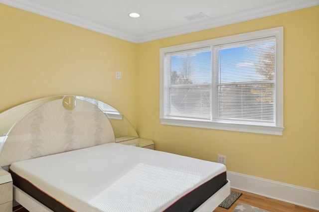 bedroom with crown molding, recessed lighting, visible vents, wood finished floors, and baseboards