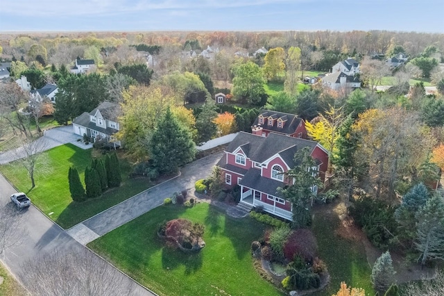 drone / aerial view featuring a wooded view