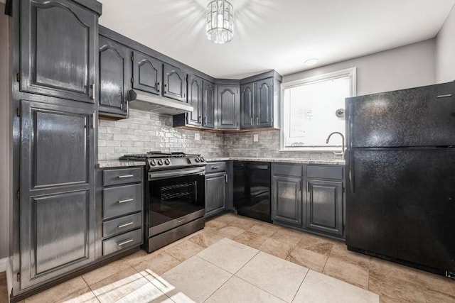 kitchen featuring light stone countertops, decorative backsplash, black appliances, and sink