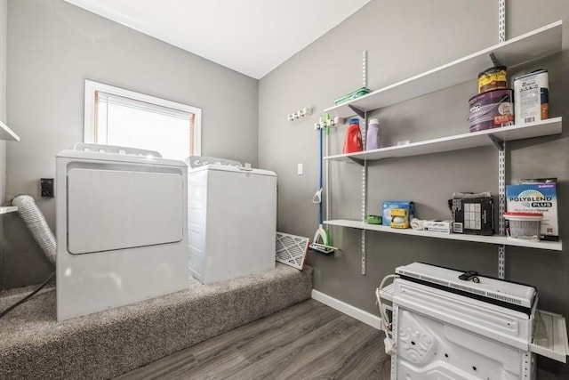 laundry area featuring independent washer and dryer and dark hardwood / wood-style flooring