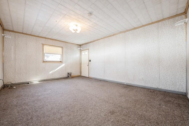 carpeted empty room featuring ornamental molding