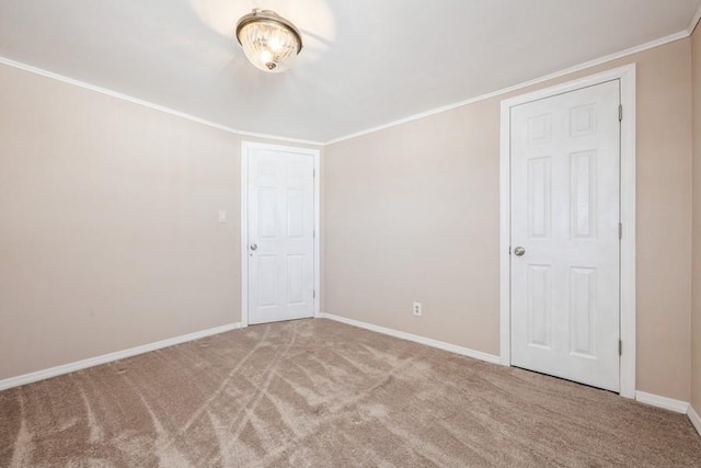 unfurnished room featuring crown molding and light carpet