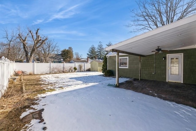 yard covered in snow featuring ceiling fan