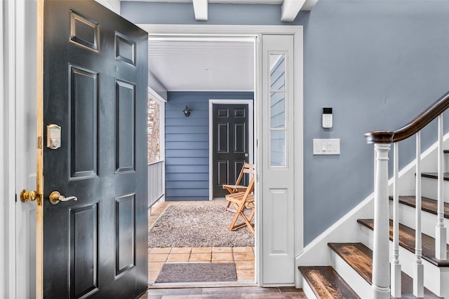 entrance foyer featuring stairway and tile patterned floors