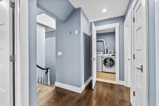 laundry room with dark wood-style floors, separate washer and dryer, and baseboards