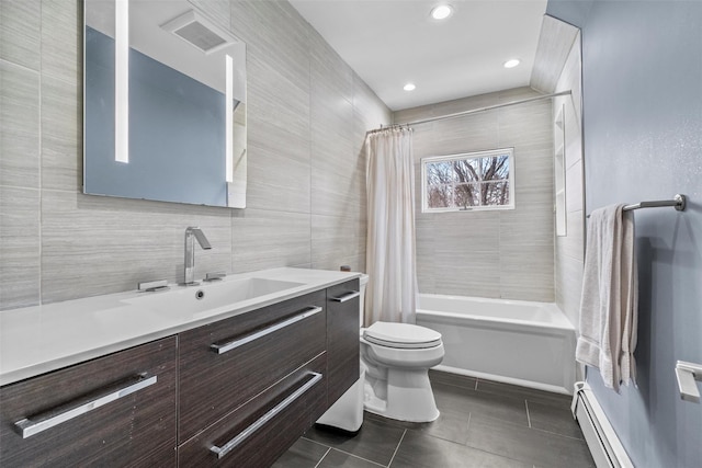 bathroom with shower / bath combo, toilet, tile patterned flooring, vanity, and tile walls