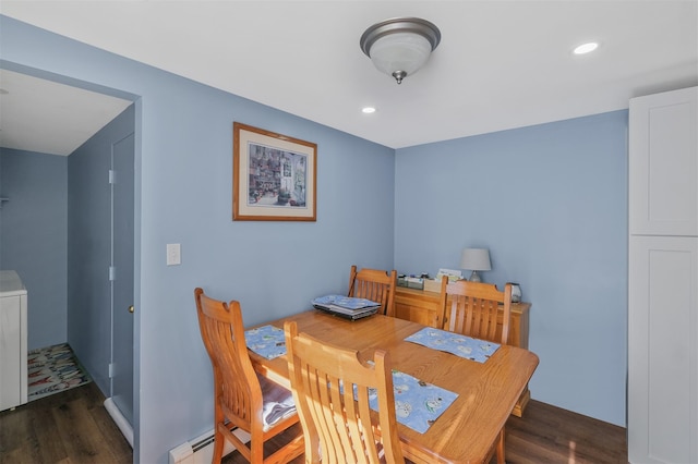 dining space with a baseboard radiator and dark hardwood / wood-style floors