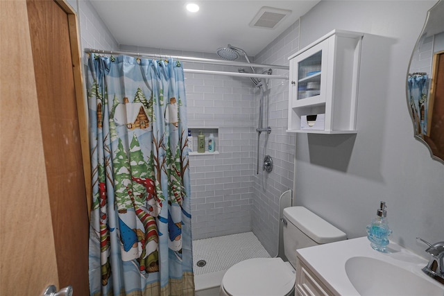 bathroom featuring vanity, toilet, and walk in shower