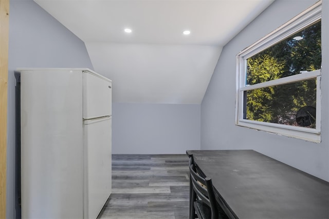 additional living space with lofted ceiling and hardwood / wood-style flooring