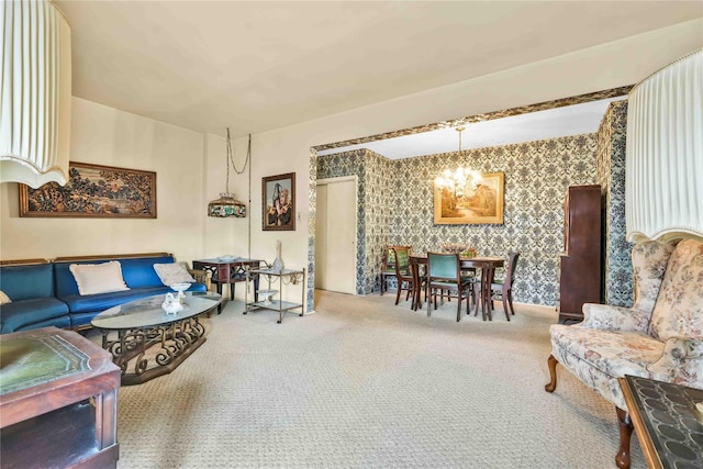 carpeted living room featuring an inviting chandelier