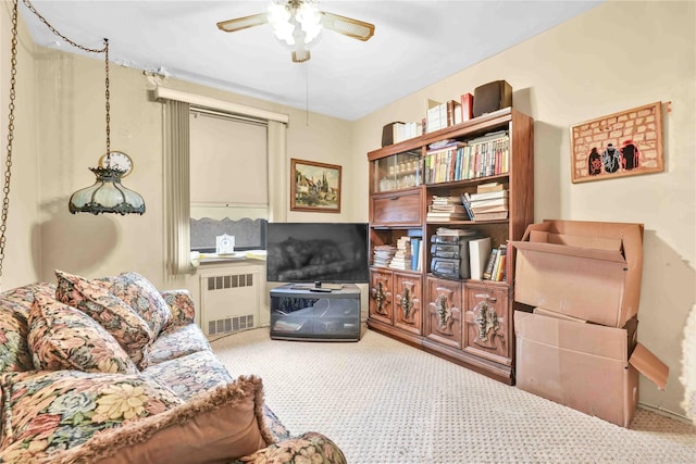 living area with radiator and ceiling fan