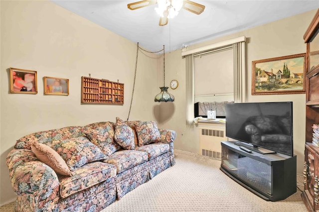 carpeted living room with ceiling fan and radiator heating unit