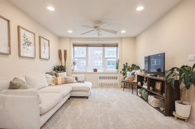 carpeted living room featuring radiator and ceiling fan