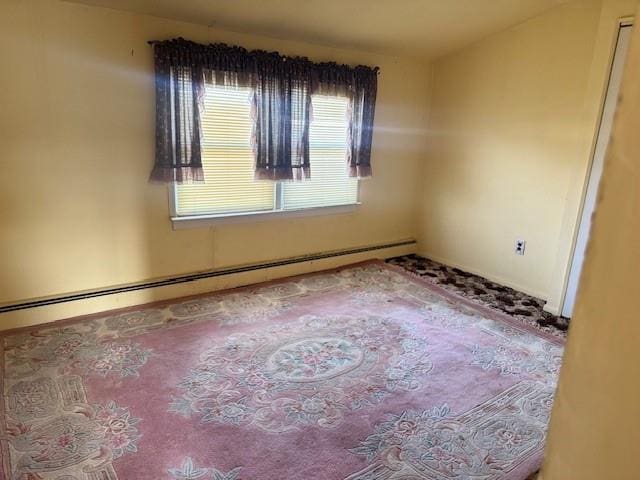 empty room featuring a baseboard heating unit