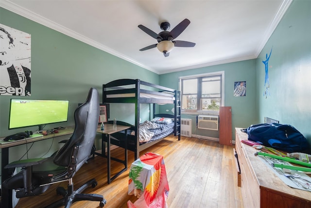 bedroom with hardwood / wood-style flooring, a wall unit AC, radiator heating unit, ceiling fan, and crown molding