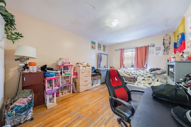 home office with light hardwood / wood-style flooring