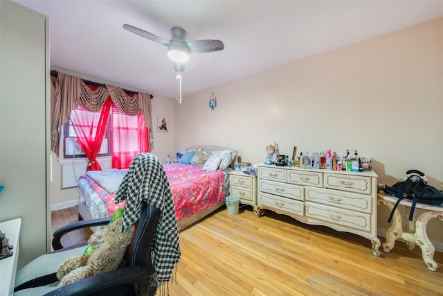 bedroom with ceiling fan and light hardwood / wood-style floors