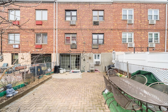 rear view of house with a patio and cooling unit