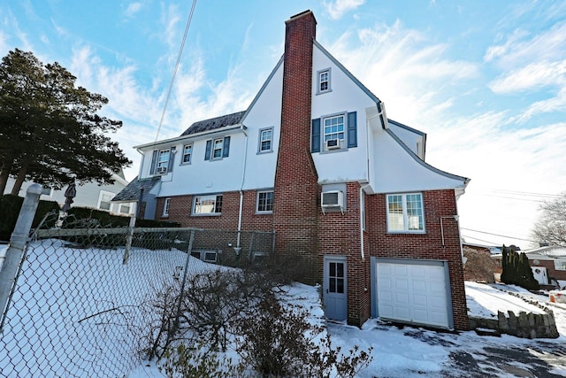 view of snow covered exterior featuring a garage