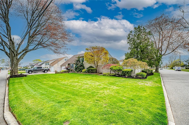 view of front facade featuring a residential view and a front lawn