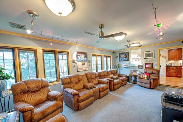 living room featuring carpet floors, visible vents, ornamental molding, and plenty of natural light