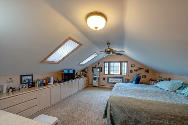 bedroom featuring lofted ceiling with skylight and light carpet