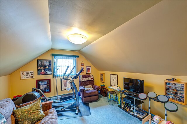 exercise room featuring carpet flooring and vaulted ceiling