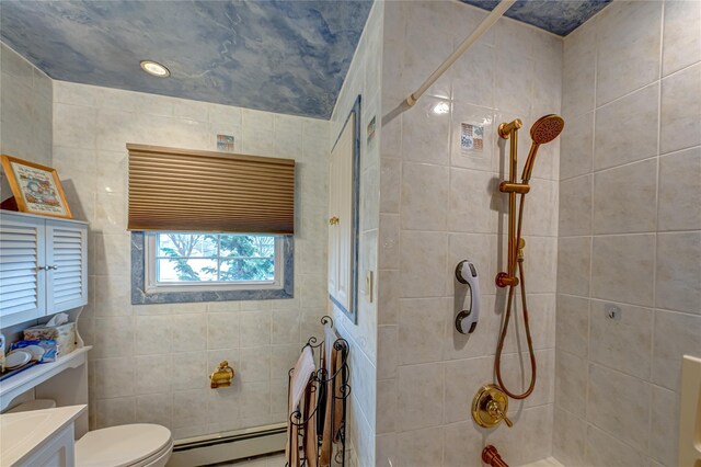 bathroom with vanity, a baseboard radiator, a tile shower, and toilet