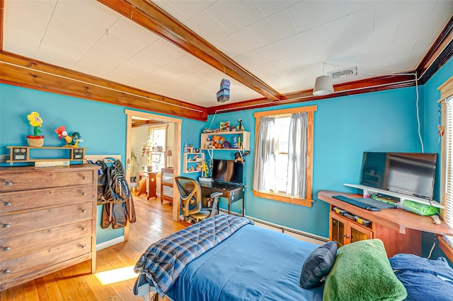 bedroom with visible vents, beamed ceiling, and hardwood / wood-style flooring