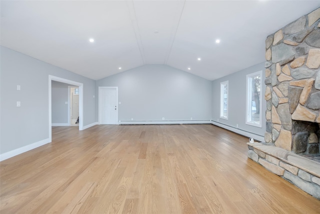 unfurnished living room with baseboard heating, lofted ceiling, a fireplace, and light wood-type flooring