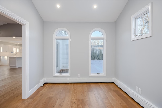 unfurnished room featuring sink and light hardwood / wood-style flooring