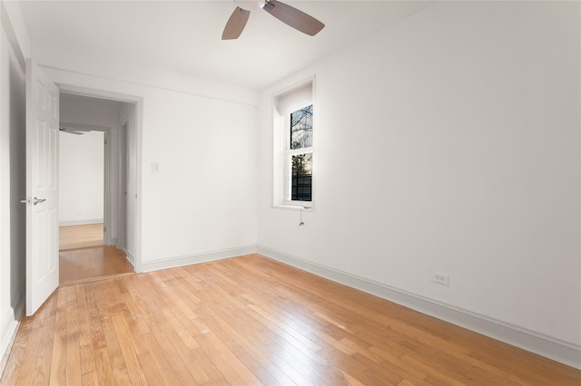 spare room with ceiling fan and light wood-type flooring